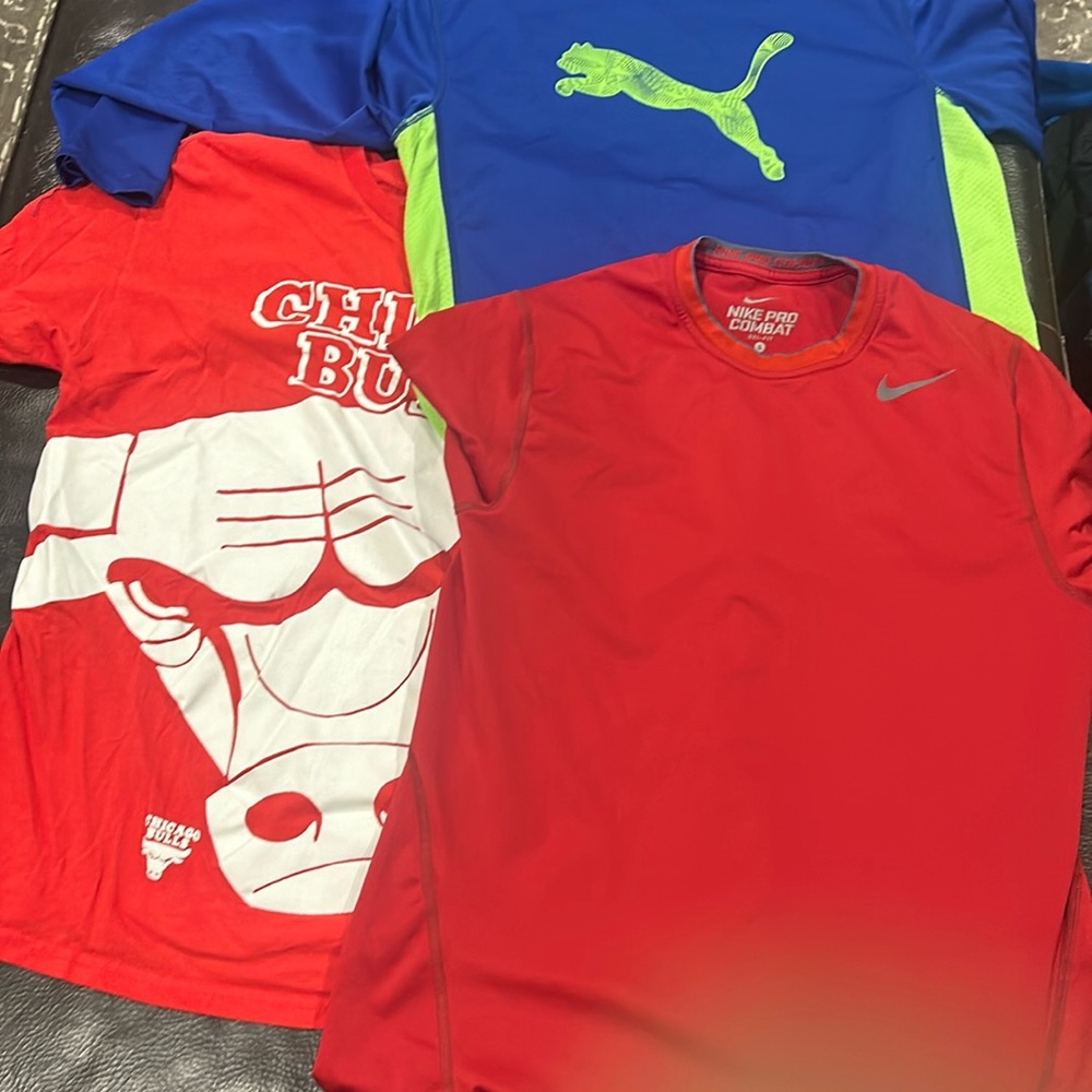 Three shirts, one Chicago Bulls, one long sleeve puma, and one Nike combat